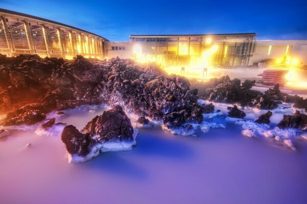 An unusual picture of winter frozen sea stones in ice lights