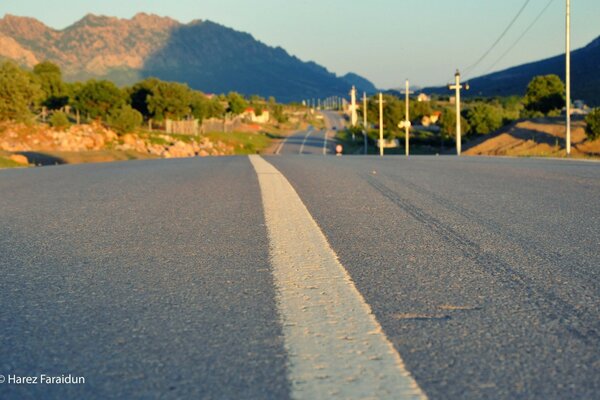 The road to macro on the background of green mountains