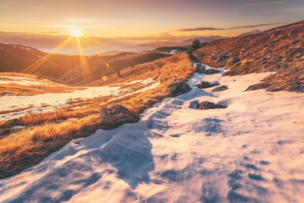 The rising sun in the snowy mountains