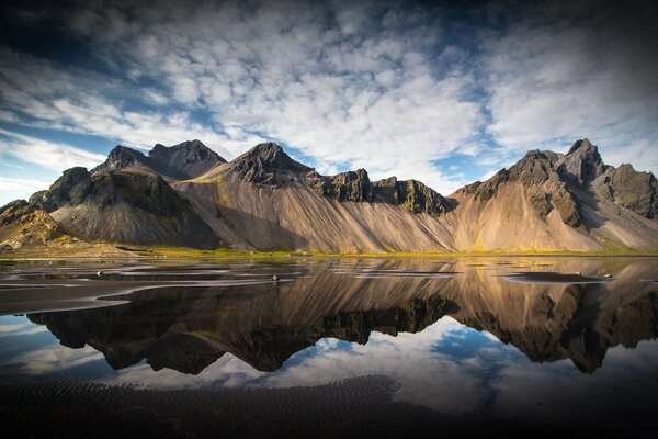 Landscape of rocky mountains above the water