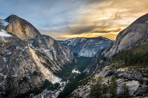 Spectacular sunset against the backdrop of mountains covered with snow