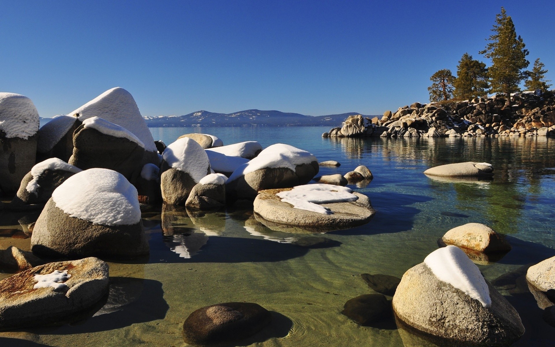 lake water rock travel beach seashore outdoors sea landscape sky snow nature ocean