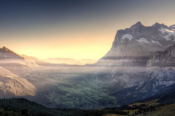 A valley among the mountains in the fog