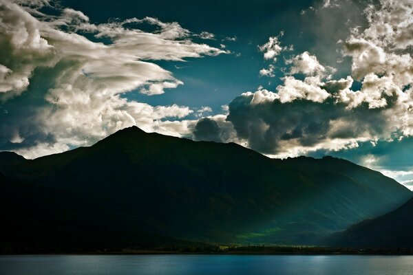 Green mountains on the river bank