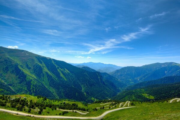 A landscape of mountains and a road stretching into the distance