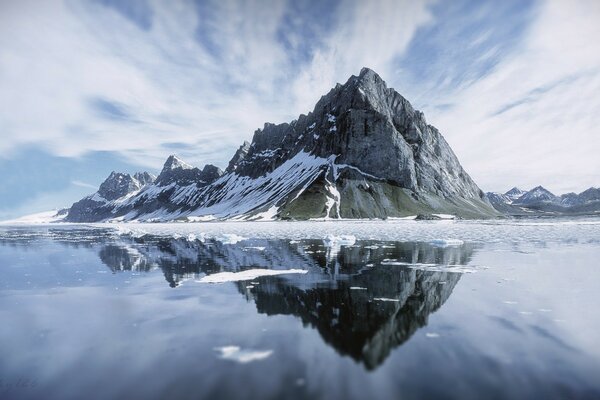 Reflection of the mountain on the ice lake