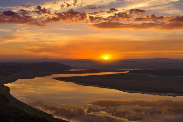 Dawn at the foot of a fast river