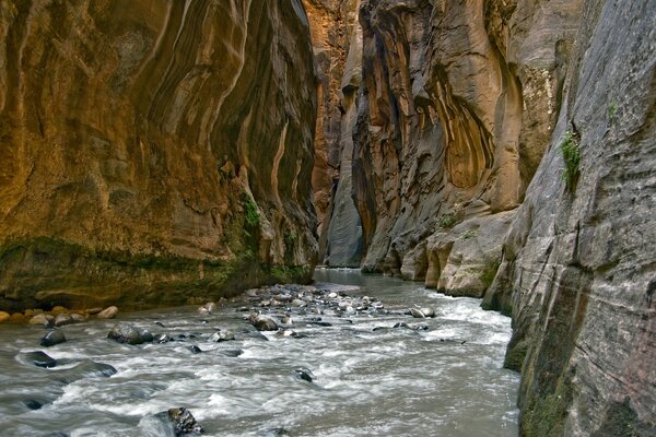 Rocky mountain stream and steep cliffs