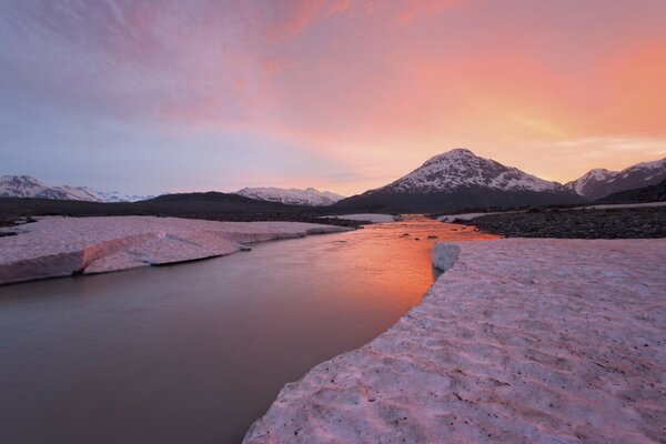 A cold river in the middle of the white mountains