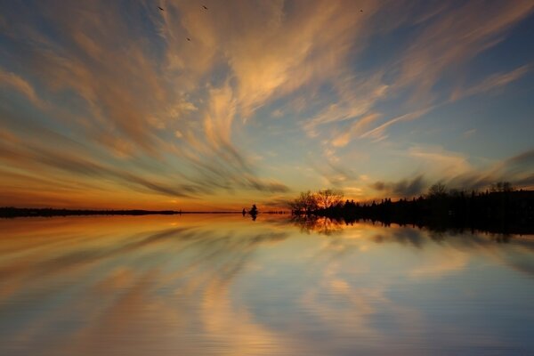 Sunrise. Merging of the sky with water