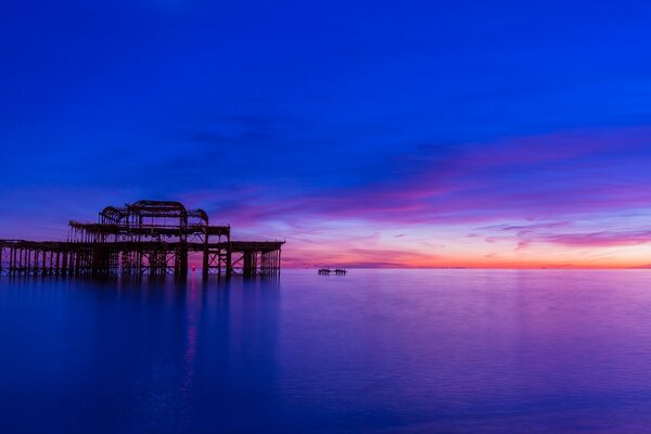 Platform in the water on the background of sunset