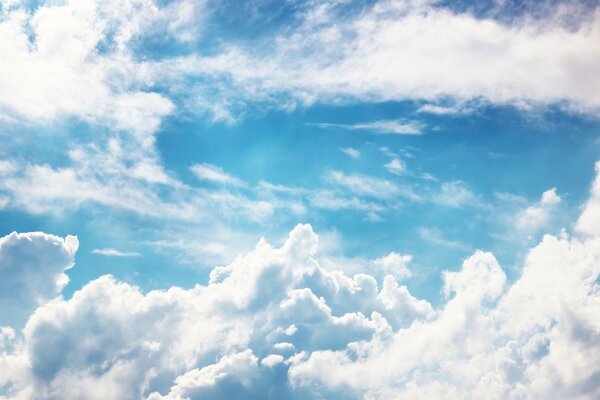 Downy clouds on a blue sky background