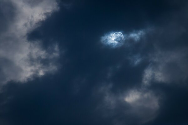 Solar eclipse in gray clouds