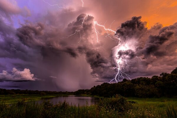 Thunderclouds on the lake in the forest