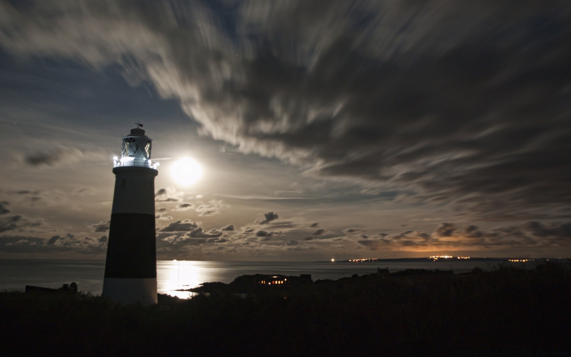 the sky lighthouse sunset dawn evening dusk light beach ocean sea landscape sky seashore water storm sun backlit outdoors travel moon