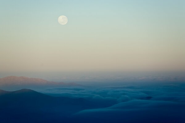 Full moon. Snowy hills. Night