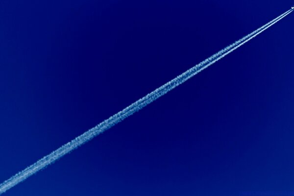 The trail of an airplane in the night sky