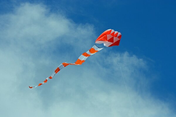 A bright kite flying in the blue sky