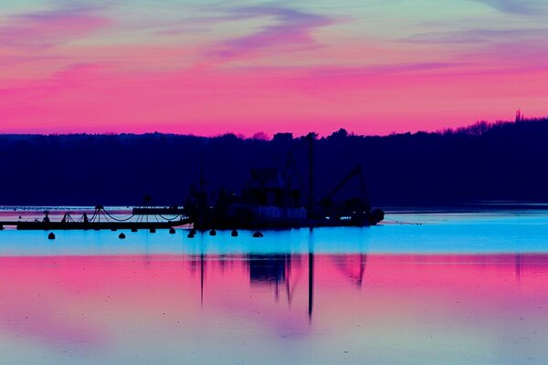 Bright scarlet dawn by the water