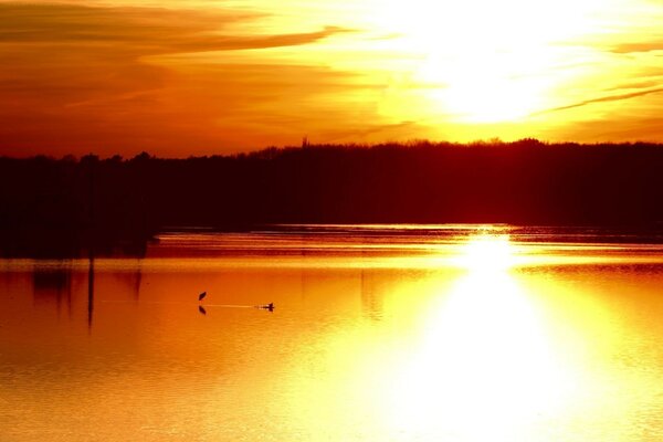 A beautiful sunset is reflected in the water