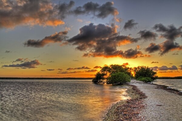 A thin sand spit leading to sunset