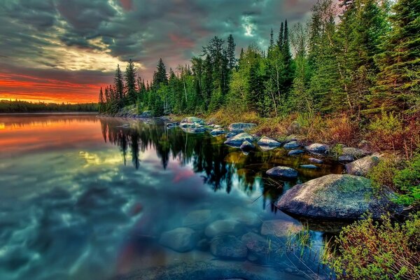 The sunset is reflected in the water of the river