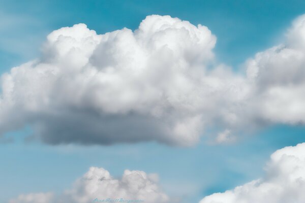 Fluffy clouds. Blue sky