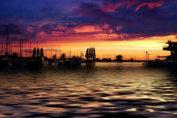 A bright sunset in the twilight by the water