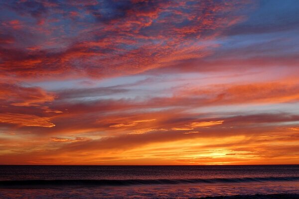 Beautiful sea sunset with illuminated clouds