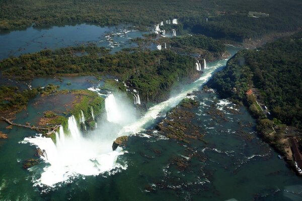 Green landscape with stormy waterfalls