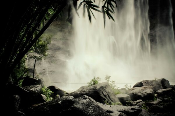 A large waterfall with trees on the right