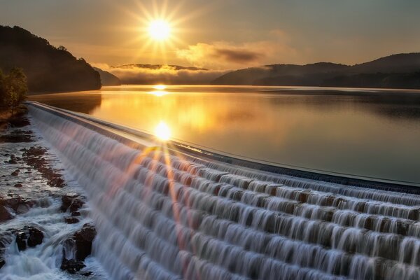 The glare of the sun on the smooth surface of the water