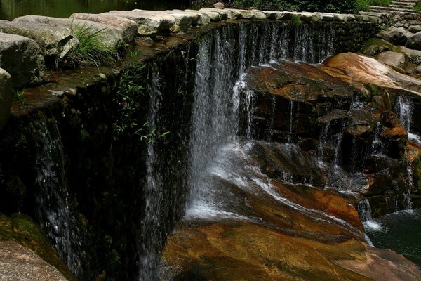 Beautiful waterfalls descend on the rocks