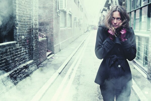 Girl in cold autumn snow