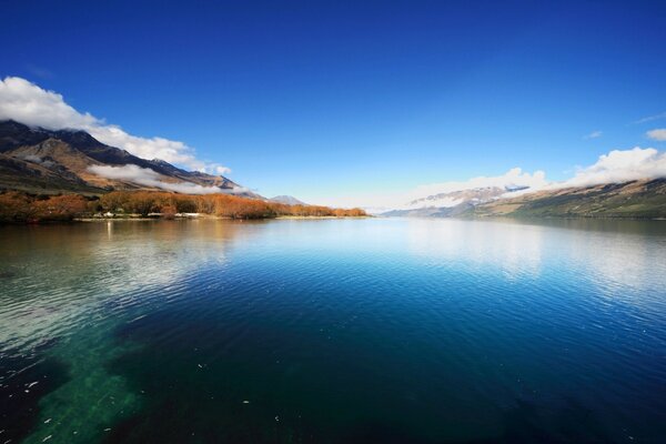 The surface of the reservoir in the mountains daytime color photo