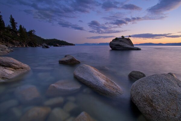 Rocky seashore. Twilight. Sunset by the water