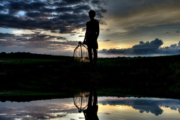 A man at sunset by the water