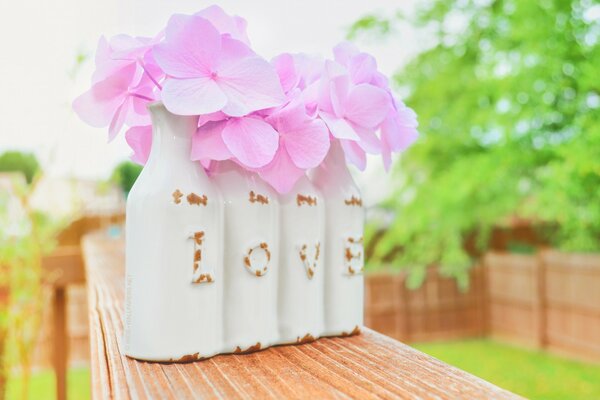 Vases made of bottles with pink flowers