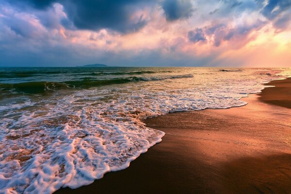 Sunset on the sandy ocean shore