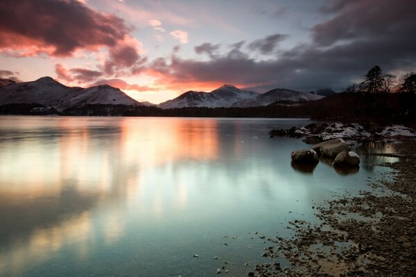 Pôr do sol do lago sobre belas montanhas