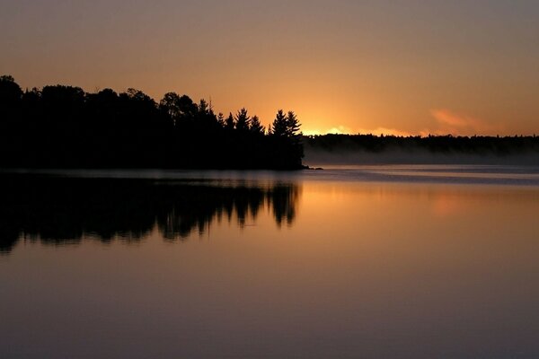 Evening sunset and sunrise over the waters of the lake