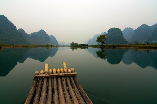 Reflection of the beautiful nature of mountains and trees in the river