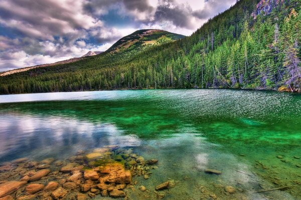 A LAKE WITH CLEAR WATER AMONG THE HILLS