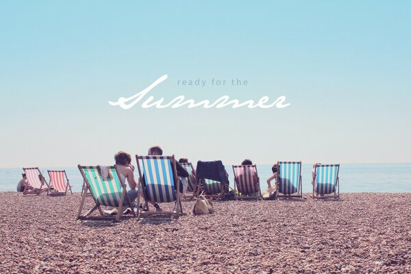 Relaxing on the beach on a chaise longue