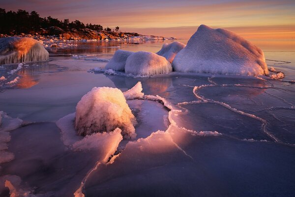 Icy winter water at sunset