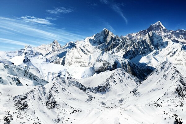 Snowy peaks on a blue sky background