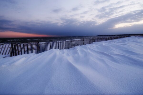 Snow-covered shore of the reservoir