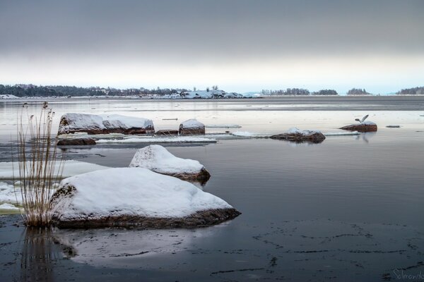 Snow with ice in winter on the water