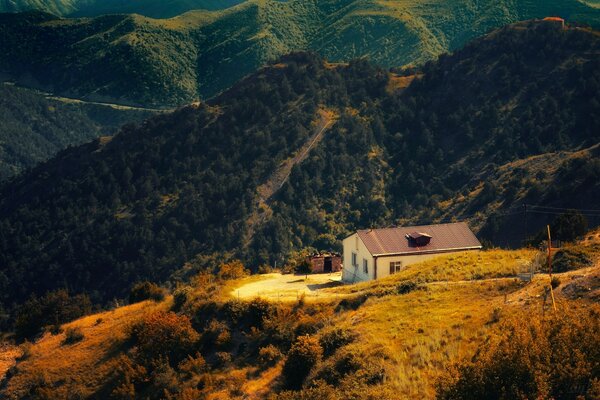 A house in the middle of a picturesque mountainous area