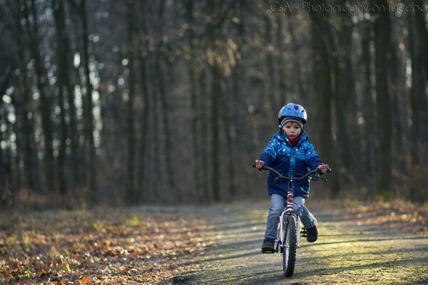 A boy rides a bicycle